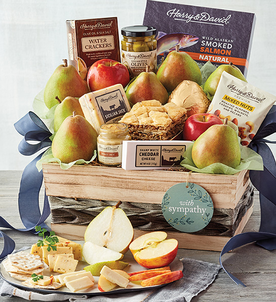 Sympathy gift ideas image - Harry & David Grand Sympathy Gift Basket with sliced cheese, pear, apple and crackers displayed in front.