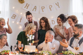 Birthday traditions around the world image - A senior man with multigeneration family celebrating birthday on indoor party.
