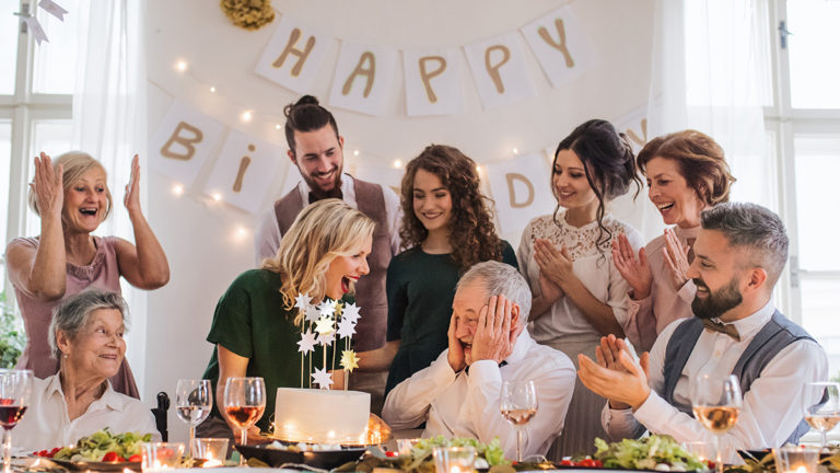 Birthday traditions around the world image - A senior man with multigeneration family celebrating birthday on indoor party.