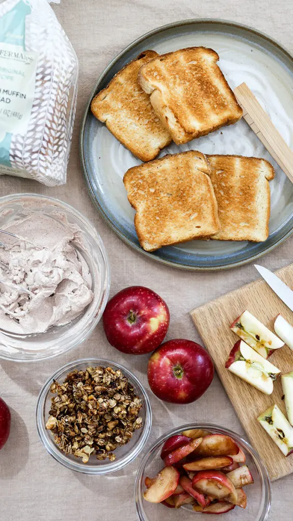 Toasted bread for apple crisp toast with ingredients surrounding it.