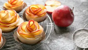 Apple image - Rack with raw rose shaped apple pastry on table