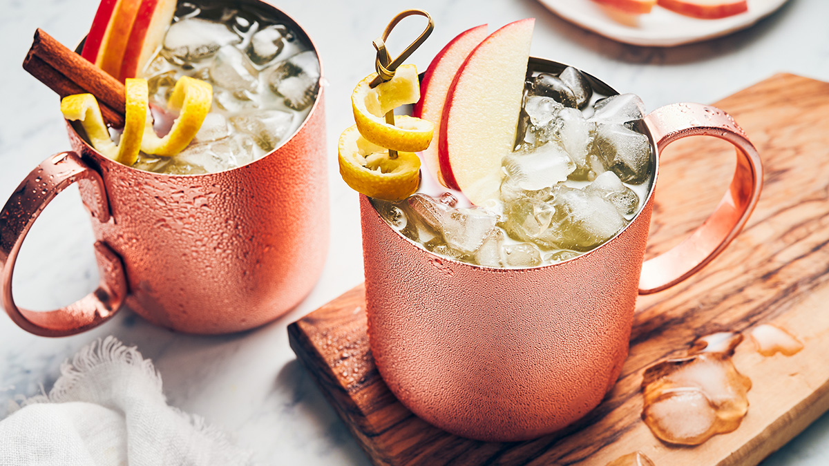 Moscow mule recipe image - moscow mule cocktail with apples, lemon twist and cinnamon