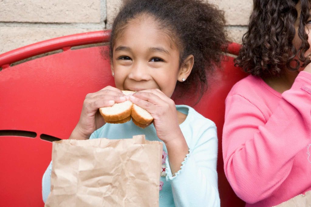 hunger and food insecurity image - girl eating sandwich