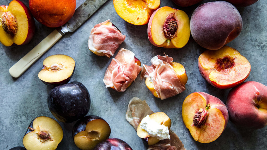 Stone fruit wrapped with prosciutto.