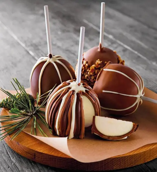 anniversary gift guide image - chocolate and caramel covered apples displayed on board