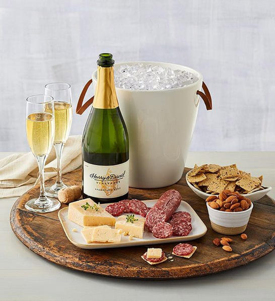 anniversary gift guide image - champagne gift with cheese, meat and two flutes