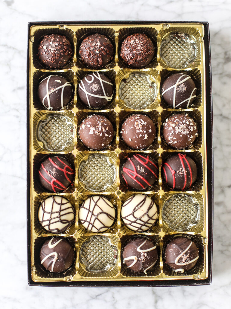 Chocolate cherry cheesecake truffles in a box.