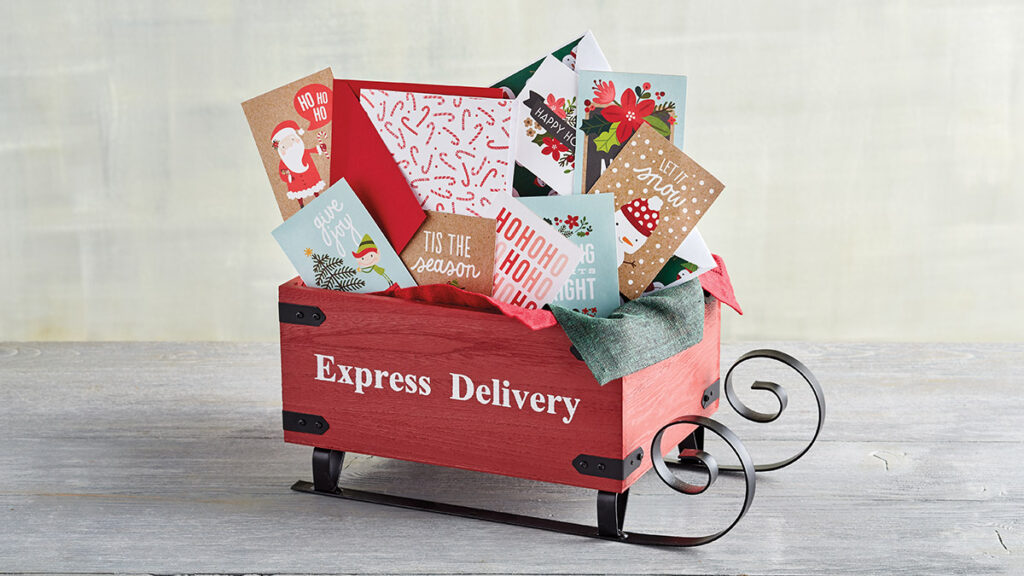 christmas quotes image - mini sleigh with the words "express delivery" on the side stuffed with christmas cards.