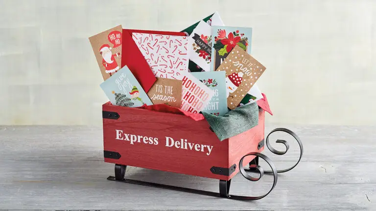 christmas quotes image - mini sleigh with the words "express delivery" on the side stuffed with christmas cards.