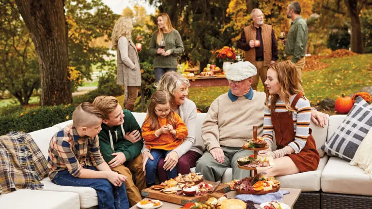 fall birthday party ideas image - family celebrating outside during the fall