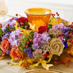 fall wreath image - fall wreath with candle holder in center on a table.