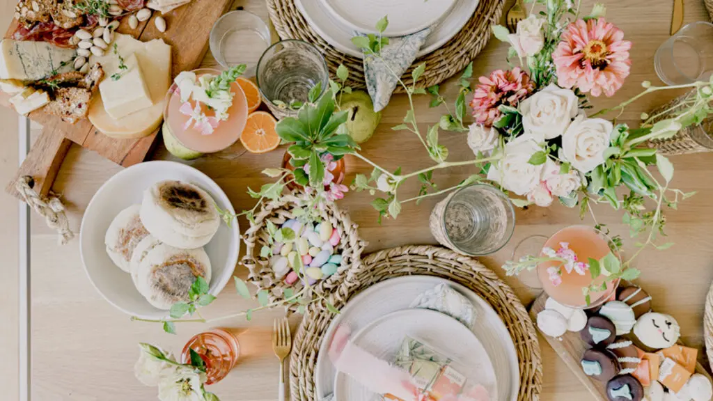 host a baby shower image - brunch tablescape with flowers, charcuterie, and cocktails