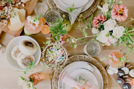 host a baby shower image - brunch tablescape with flowers, charcuterie, and cocktails