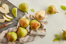 How to ripen pears with several whole and sliced pears on a counter.