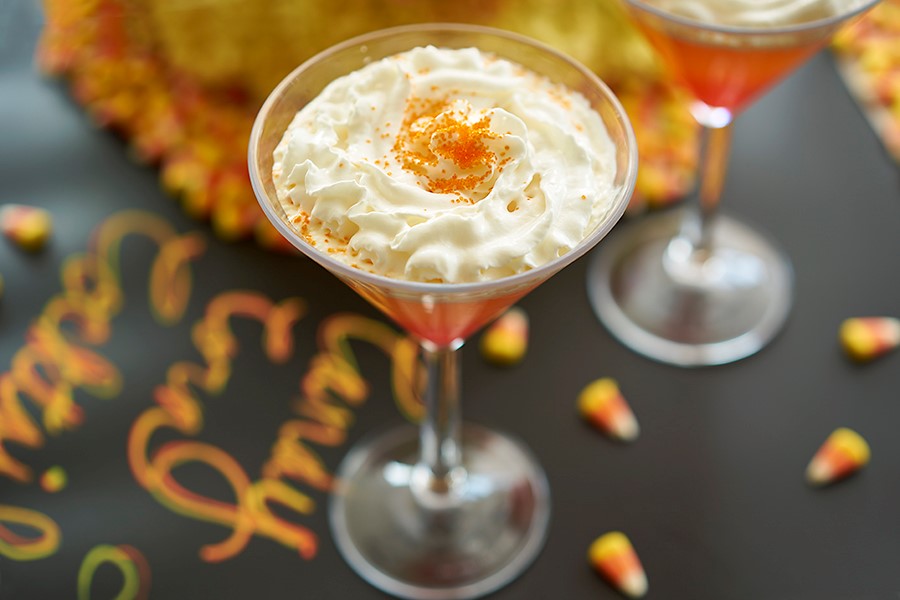 candy corn cocktail image - candy corn martini with candy corns in the background