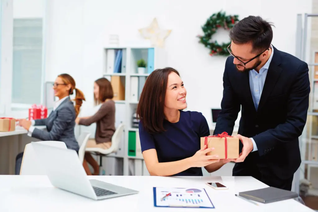 A photo of corporate gifting with coworkers exchanging gifts