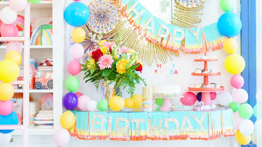 Photo of a dessert bar with balloons and desserts