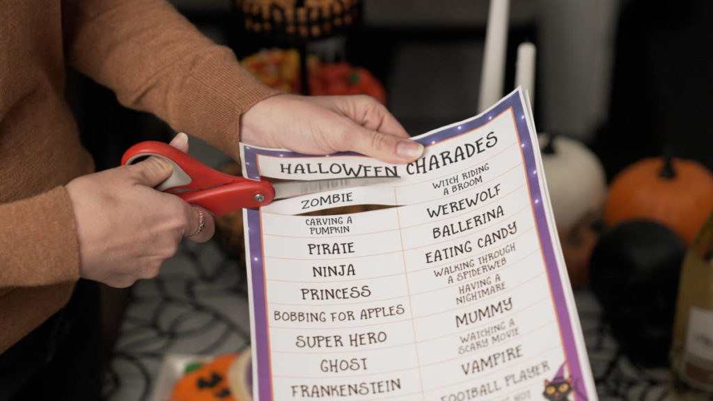 Halloween charades clues being cut up