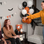 A photo of Halloween charades game with decorations in the background