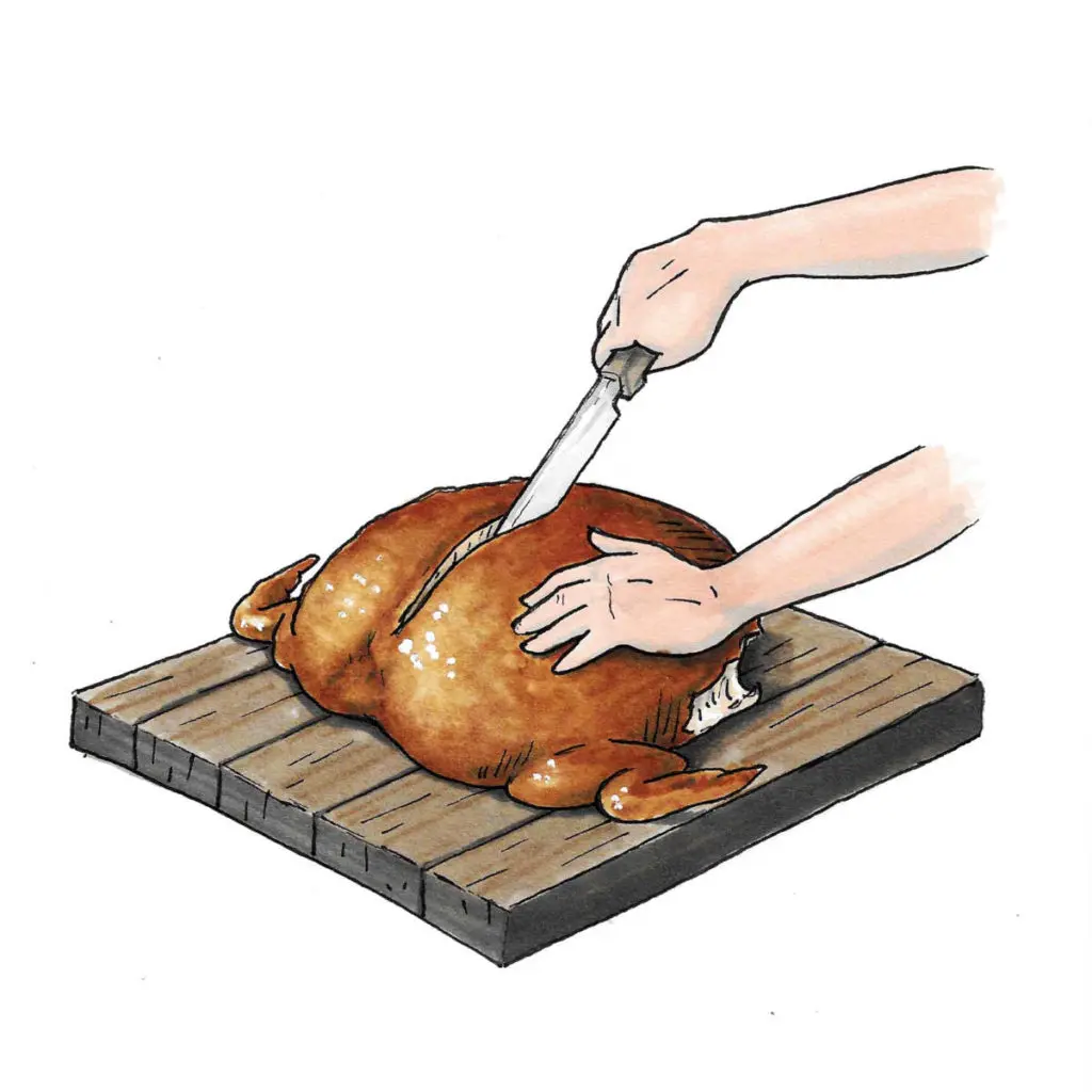 A photo of how to carve a turkey with a hand using a knife to cut through the breast of the turkey.