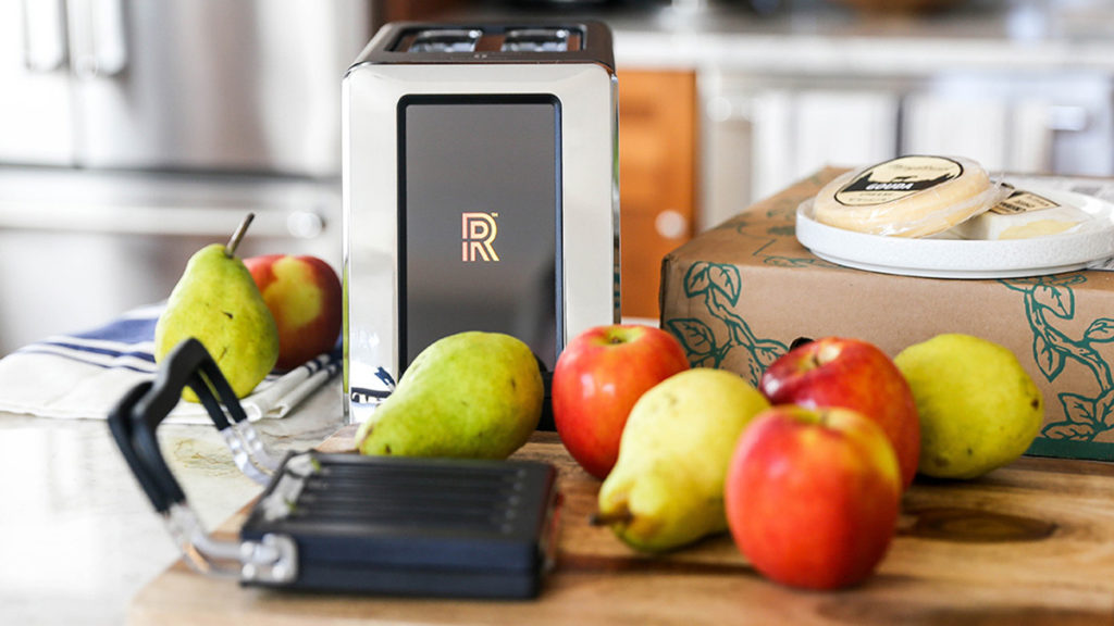 A photo of the revolution toaster surrounded by fruit