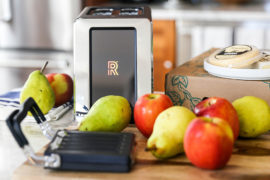 A photo of the revolution toaster surrounded by fruit