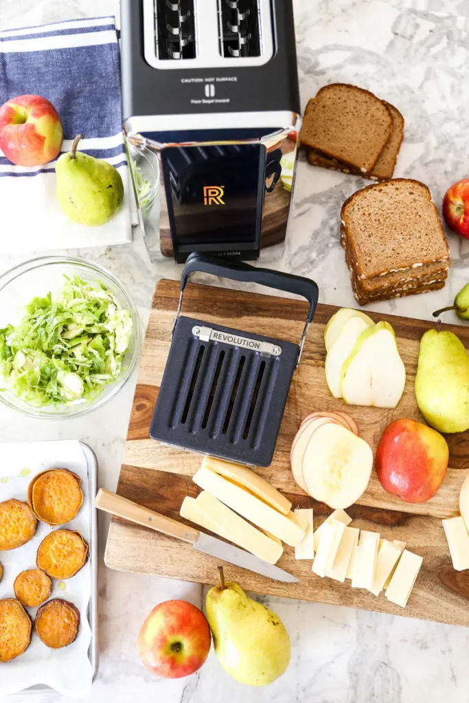 A photo of the revolution toaster with ingredients surrounding it