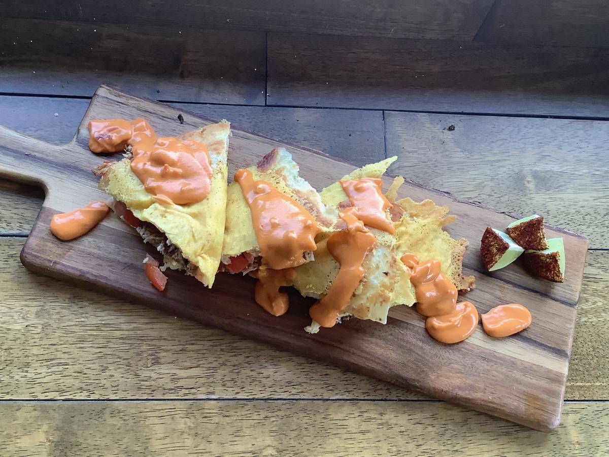 tailgate party image - brisket quesadillas with beer cheese sauce on cutting board