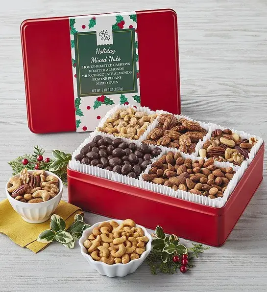 Christmas gift ideas for him with a tin of multiples kinds of nuts decorated for Christmas.