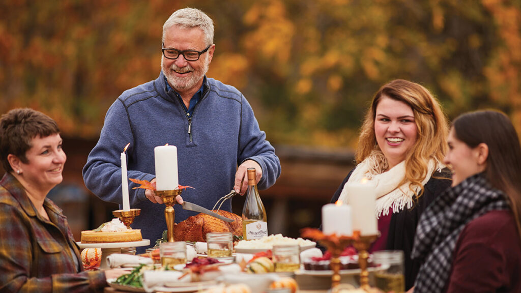 A photo of facts about thanksgiving with a group eating dinner outside