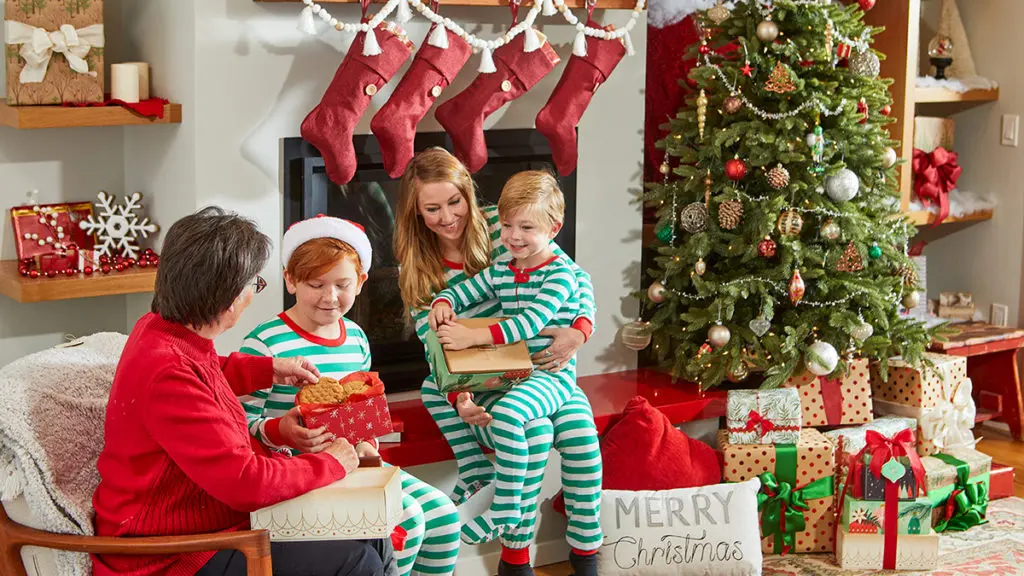 A photo of a gift guide with a family opening presents on Christmas morning