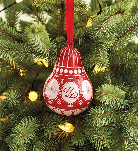 A photo of stocking stuffer ideas with a pear ornament hanging on a tree.