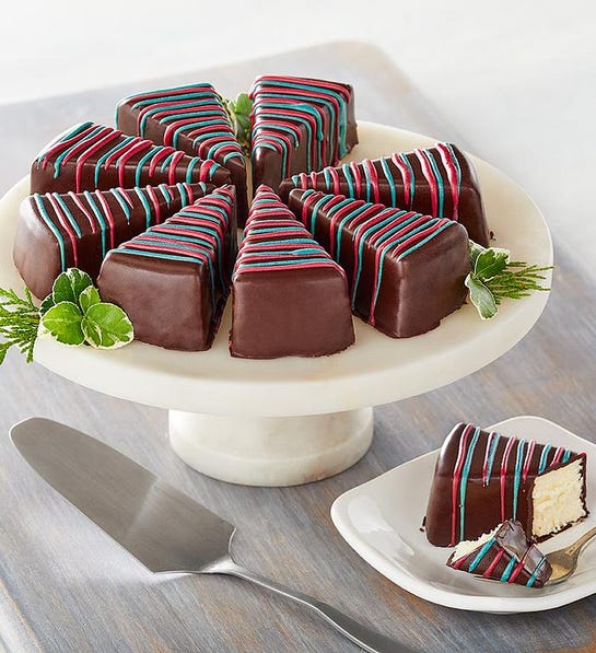 A photo of gifts under $50 with a tray of chocolate covered cheesecake triangles decorated like Christmas trees.