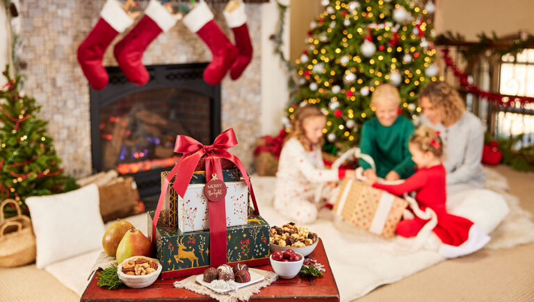 Gifts under 50 with a family opening presents underneath a Christmas tree.