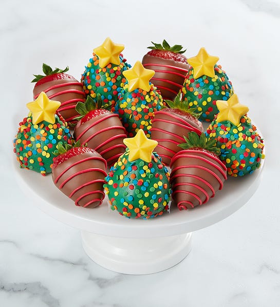 A photo of gifts under $50 with a tray of chocolate covered strawberries decorated to look like Christmas trees.