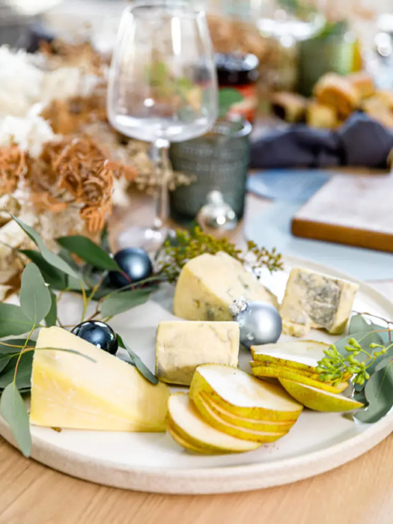 Hanukkah brunch with a plate of cheeses and sliced pears.