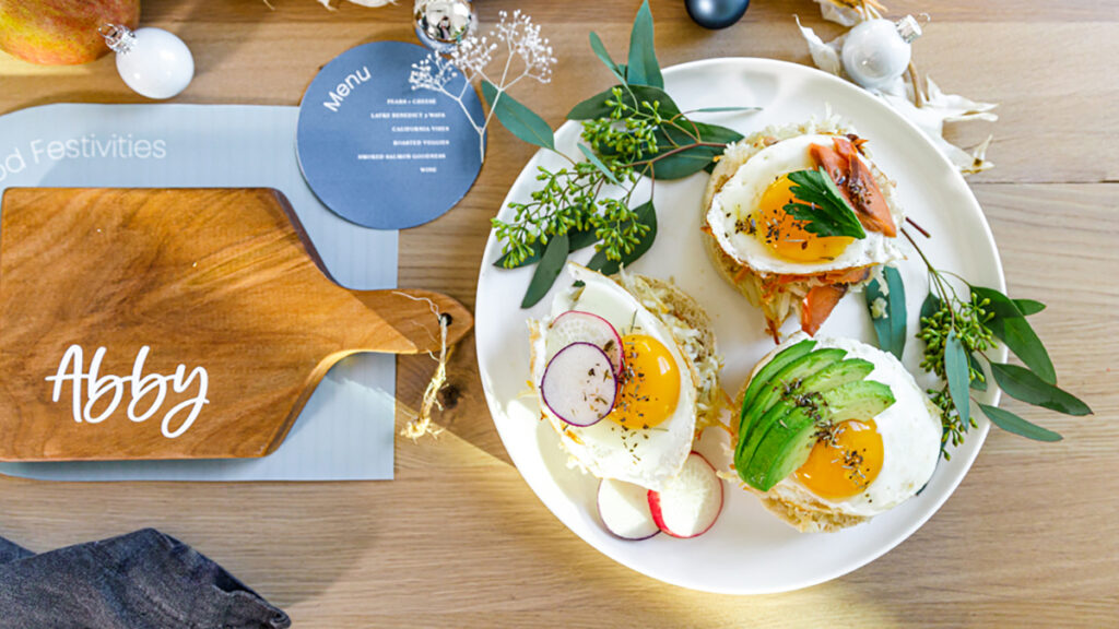 Hanukkah brunch table with a plate of eggs Benedict next to a personalized cutting board.