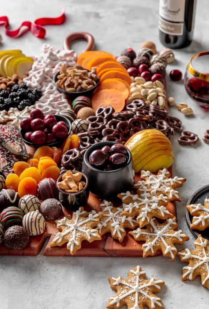 Holiday dessert board with cookies, chocolate, dried fruit and nuts