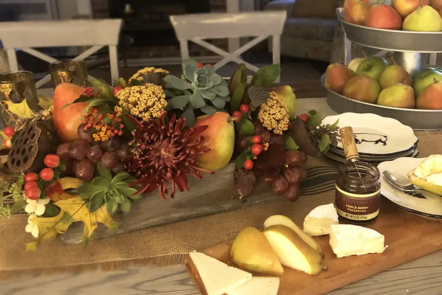 A photo of a pear tablescape next to a charcuterie board