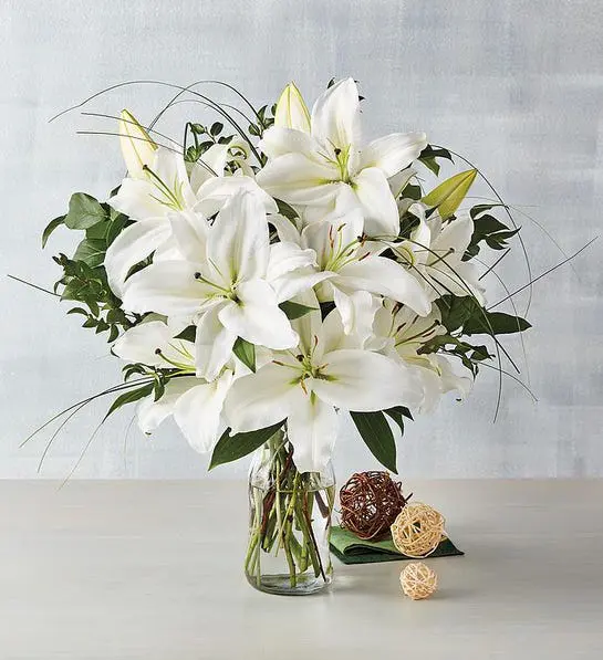 A photo of thanksgiving host gifts with a bouquet of white lilies.