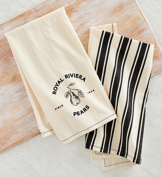 A photo of thanksgiving host gifts with two kitchen towels on a wooden table