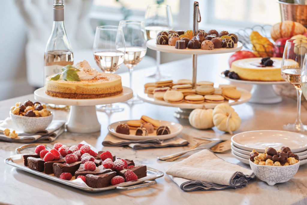 Thanksgiving host tips with a spread of desserts on a counter