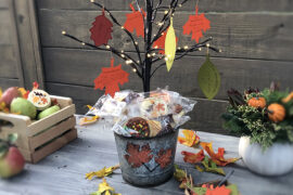 A photo of a thanksgiving tree surrounded by cookies and fruit