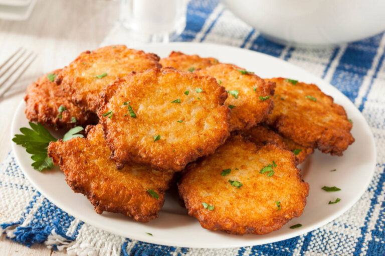 traditional hanukkah foods with a plate of potato latkes