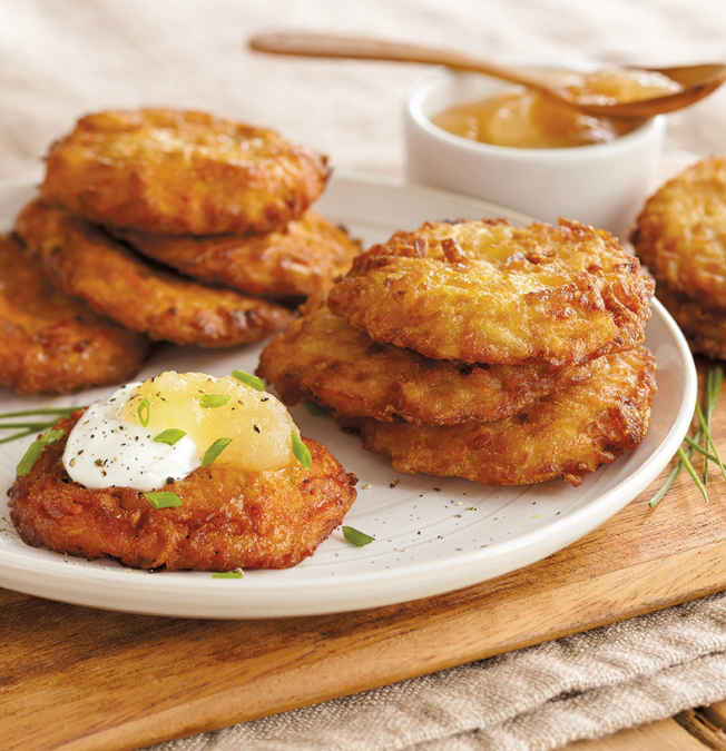 A photo of traditional Hanukkah foods with a plate of latkes
