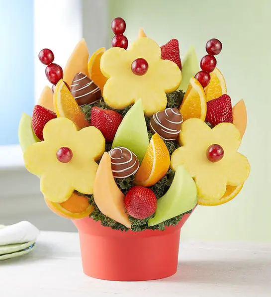 A photo of birthday gift ideas with a fruit bouquet full of chocolate and other kinds of fruit.
