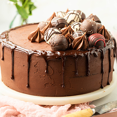 Red wine chocolate truffle cake on a stand.