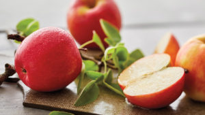 A photo of healthy fruit with apples on a cutting board