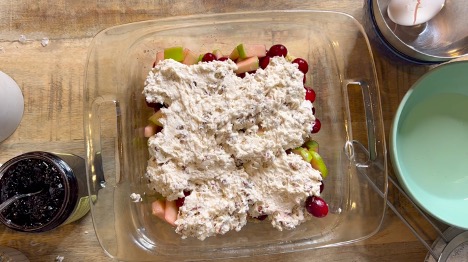 A photo of cobbler with an unbaked cobbler in a baking dish