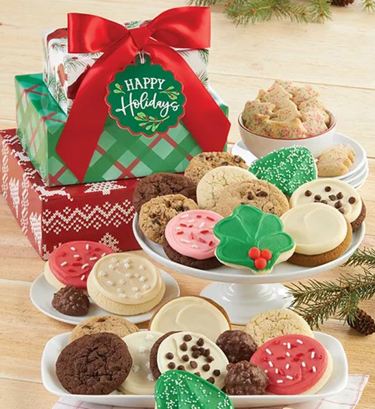 A photo of holiday gifts for employees with a stack of holiday decorated gifts behind several plates of cookies.